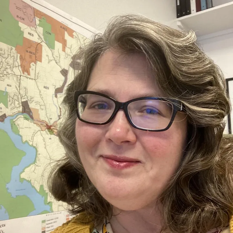 Jessica Roberts in front of a zoning districts map. 